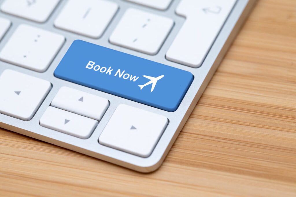 here is an image of a laptop with a ‘book now’ button