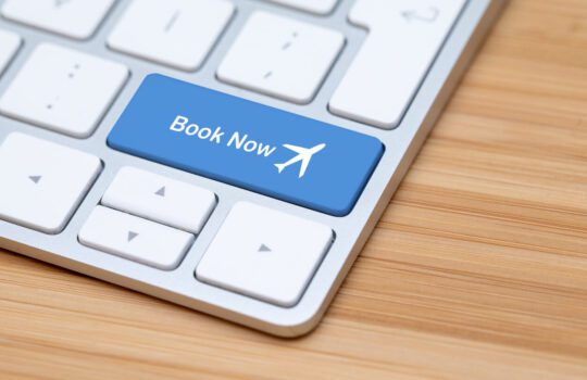 here is an image of a laptop with a ‘book now’ button