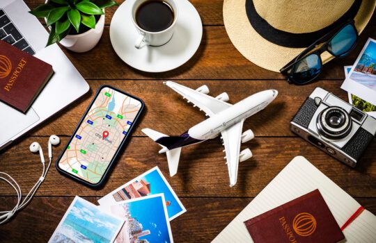 here is an image showing different aspects of travel including a passport, aeroplane, laptop, mobile phone app and more. This represents the types of travel plugin available.